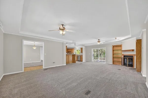wooden floor fireplace and windows in an empty room