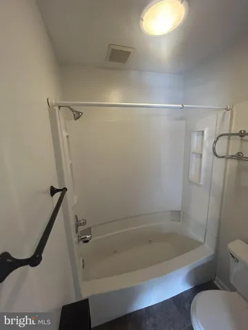 a bathroom with a shower and toilet