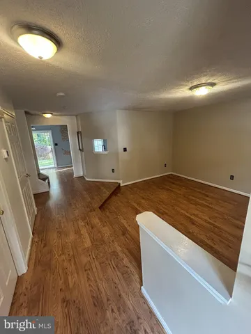 an empty room with wooden floor