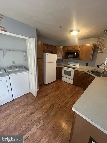 a kitchen with a sink a stove and refrigerator