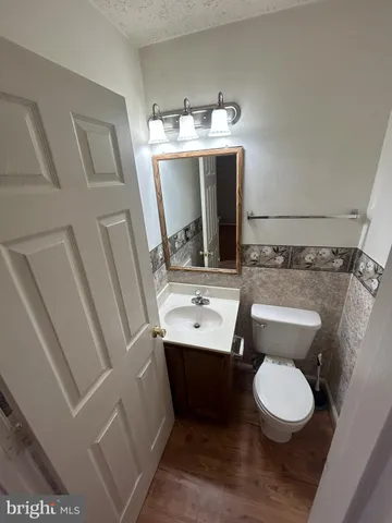 a bathroom with a sink toilet and mirror