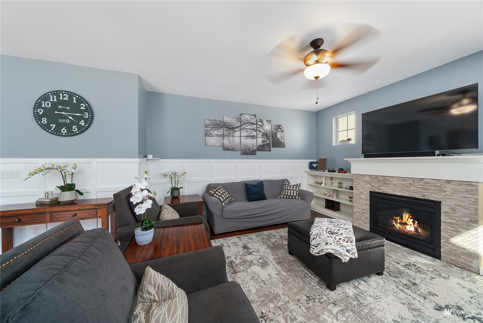1333 Farina Loop Southeast Olympia, WA 98513 - Photo 11 of 32 a living room with furniture a flat screen tv and a fireplace