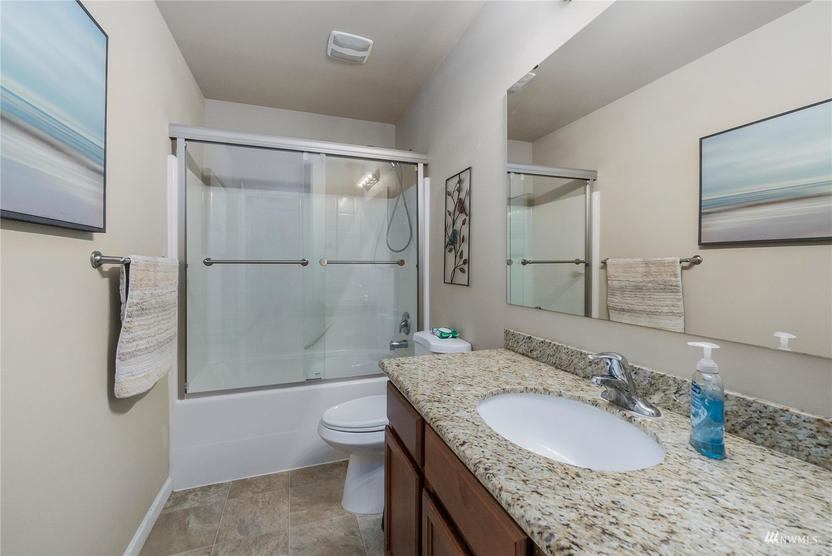 1333 Farina Loop Southeast Olympia, WA 98513 - Photo 23 of 32 a bathroom with a granite countertop sink a toilet and shower