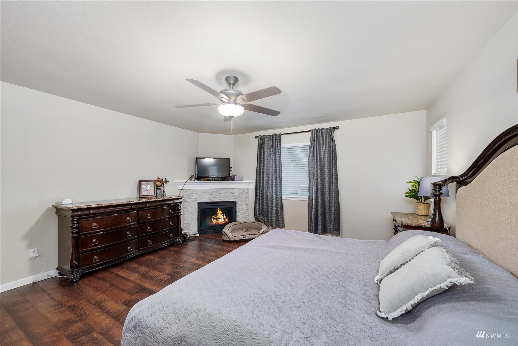 1333 Farina Loop Southeast Olympia, WA 98513 - Photo 27 of 32 a spacious bedroom with a bed and a chandelier