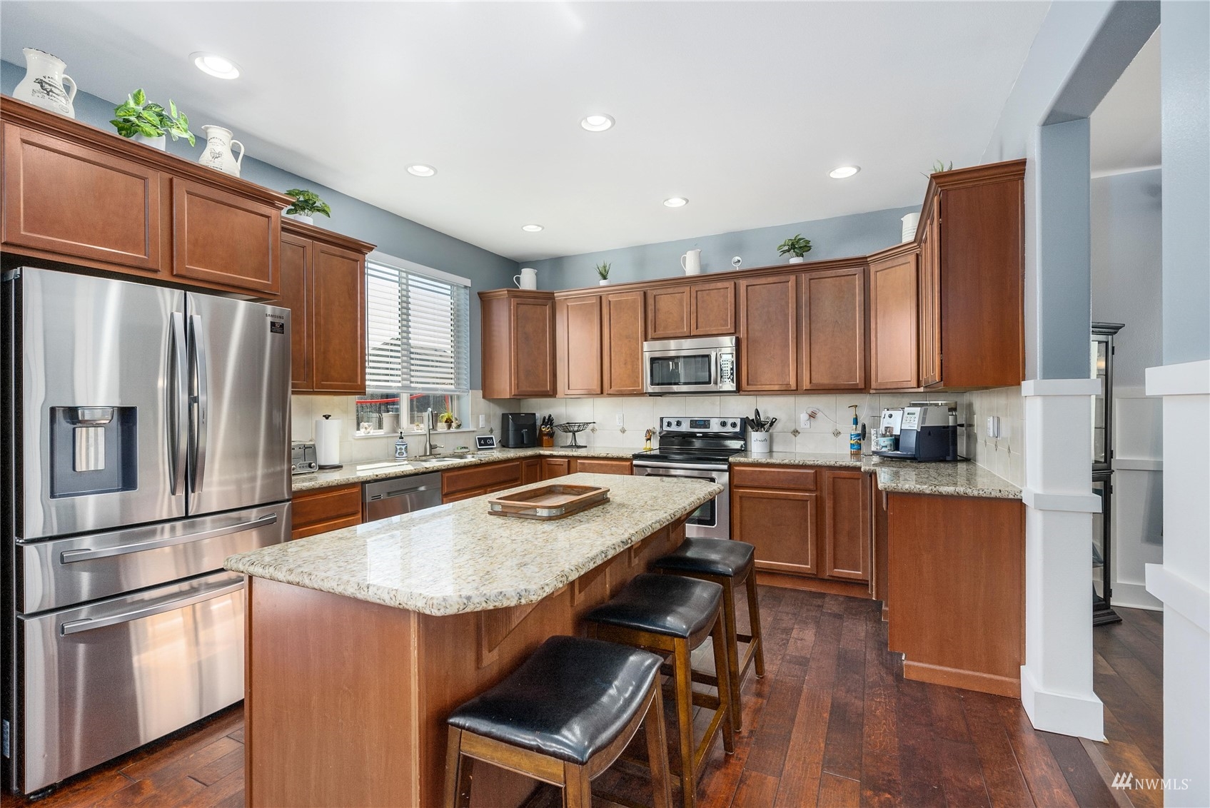 1333 Farina Loop Southeast Olympia, WA 98513 - Photo 5 of 32 a kitchen with stainless steel appliances granite countertop a refrigerator a stove top oven a sink and dishwasher