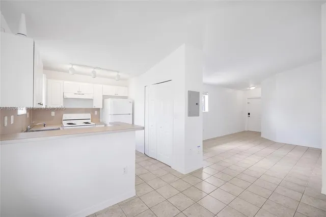 a kitchen with stainless steel appliances a refrigerator and a stove