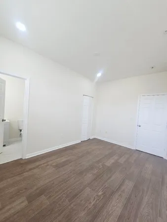 a view of an empty room with wooden floor