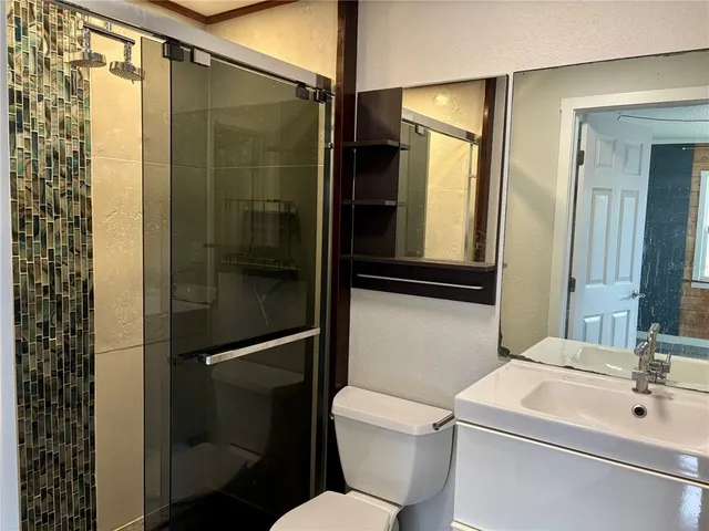 a bathroom with a sink toilet and shower