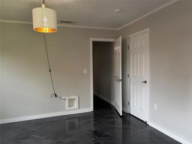 a view of a room with wooden floor
