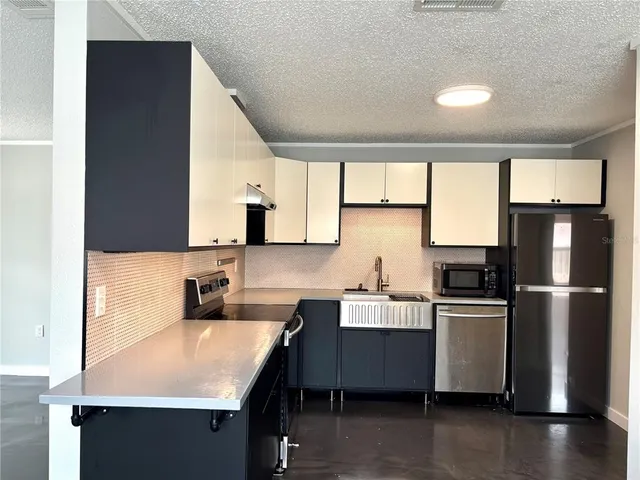 a kitchen with a sink appliances and cabinets