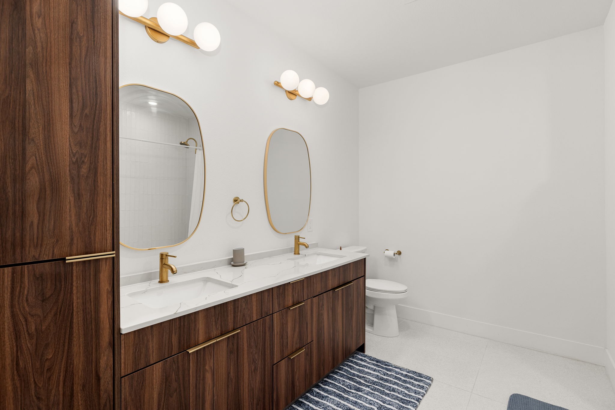 1701 Simond Avenue, Unit 612 Austin, TX 78723 - Photo 19 of 40 a bathroom with a double vanity sink and a mirror