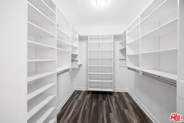 a view of walk in closet with empty racks