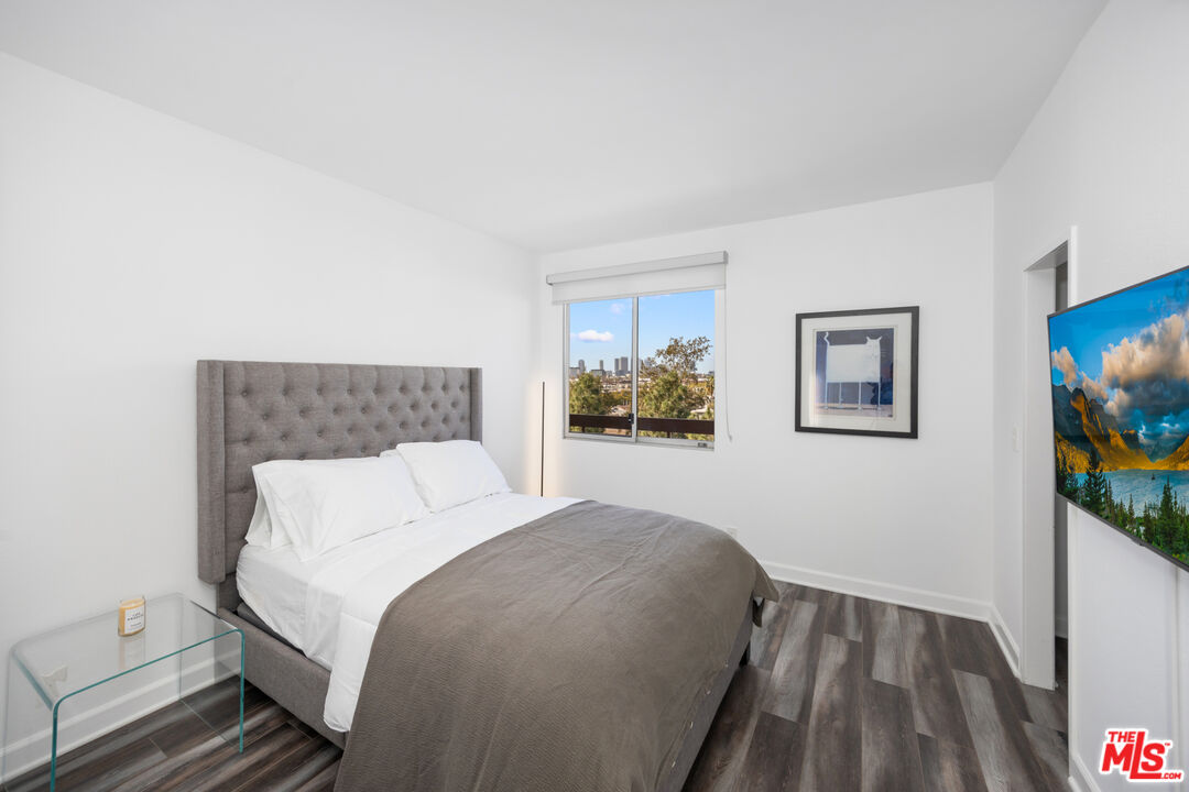 321 South San Vicente Boulevard, Unit 708 Los Angeles, CA 90048 - Photo 12 of 19 a bedroom with a bed and a flat screen tv
