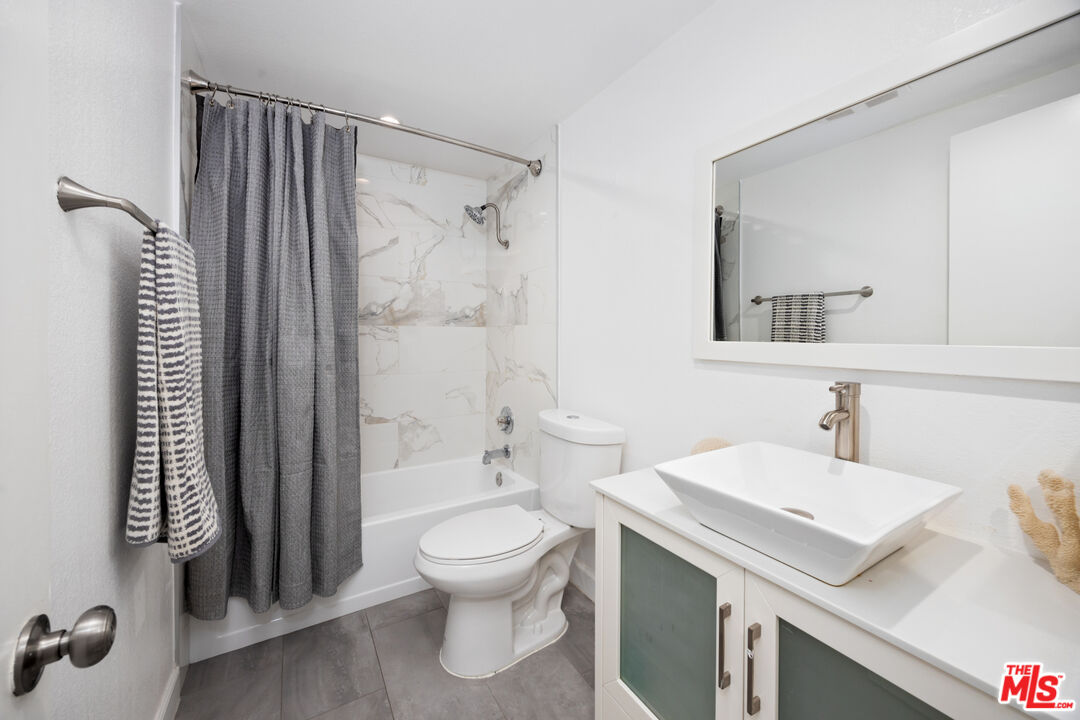 321 South San Vicente Boulevard, Unit 708 Los Angeles, CA 90048 - Photo 15 of 19 a bathroom with a sink toilet and shower