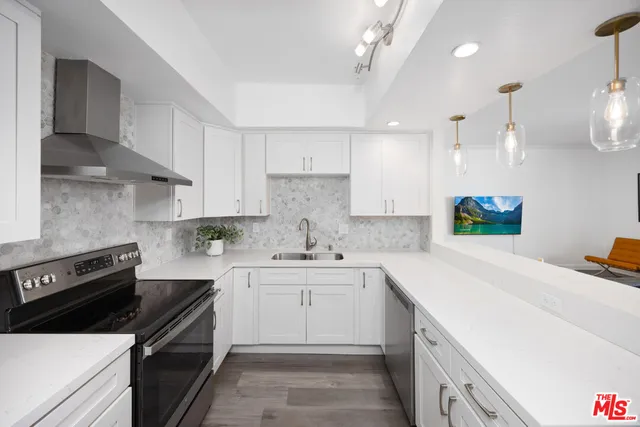 a kitchen with a sink stove and cabinets