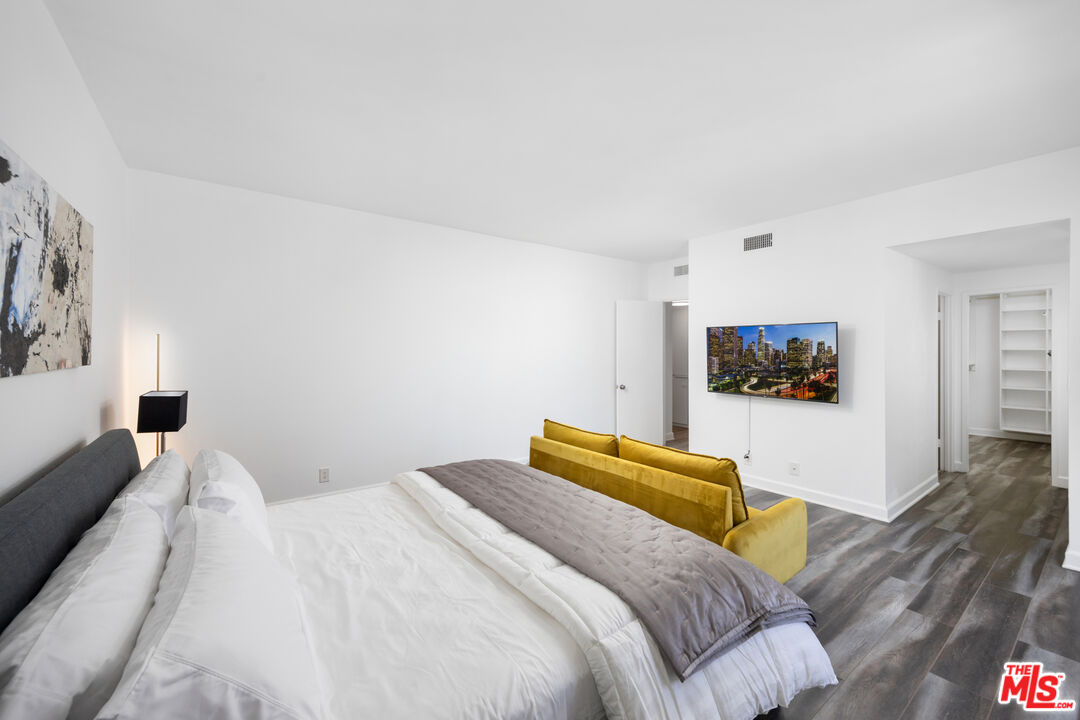 321 South San Vicente Boulevard, Unit 708 Los Angeles, CA 90048 - Photo 7 of 19 a bedroom with a bed and a flat screen tv