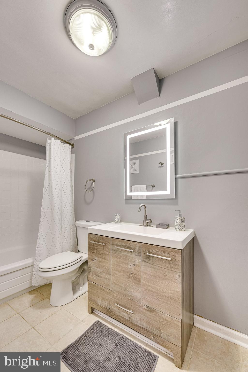 5909 B Prince James Drive, Unit B Springfield, VA 22152 - Photo 14 of 18 a bathroom with a sink a toilet and a mirror