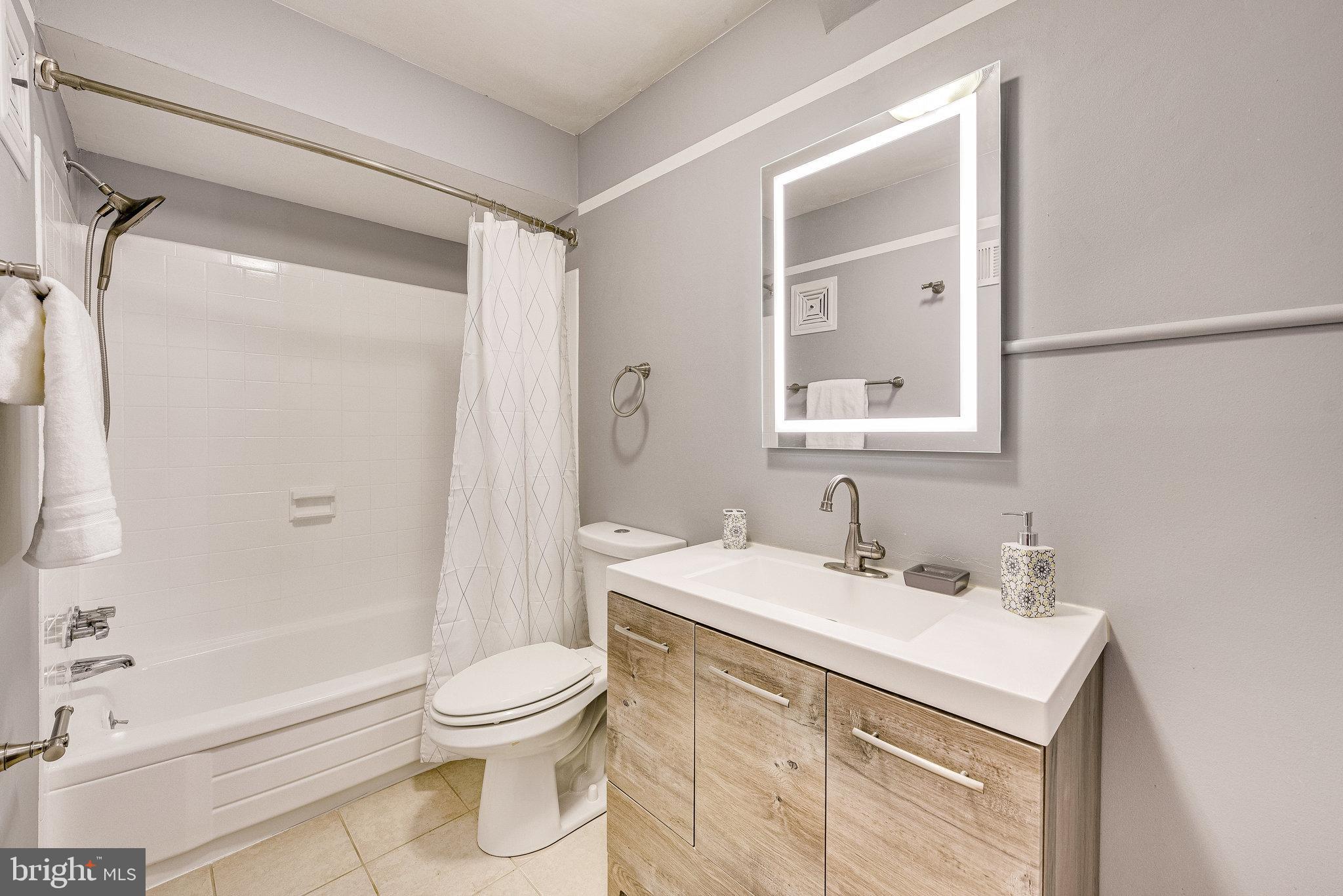 5909 B Prince James Drive, Unit B Springfield, VA 22152 - Photo 15 of 18 a bathroom with a sink toilet and shower