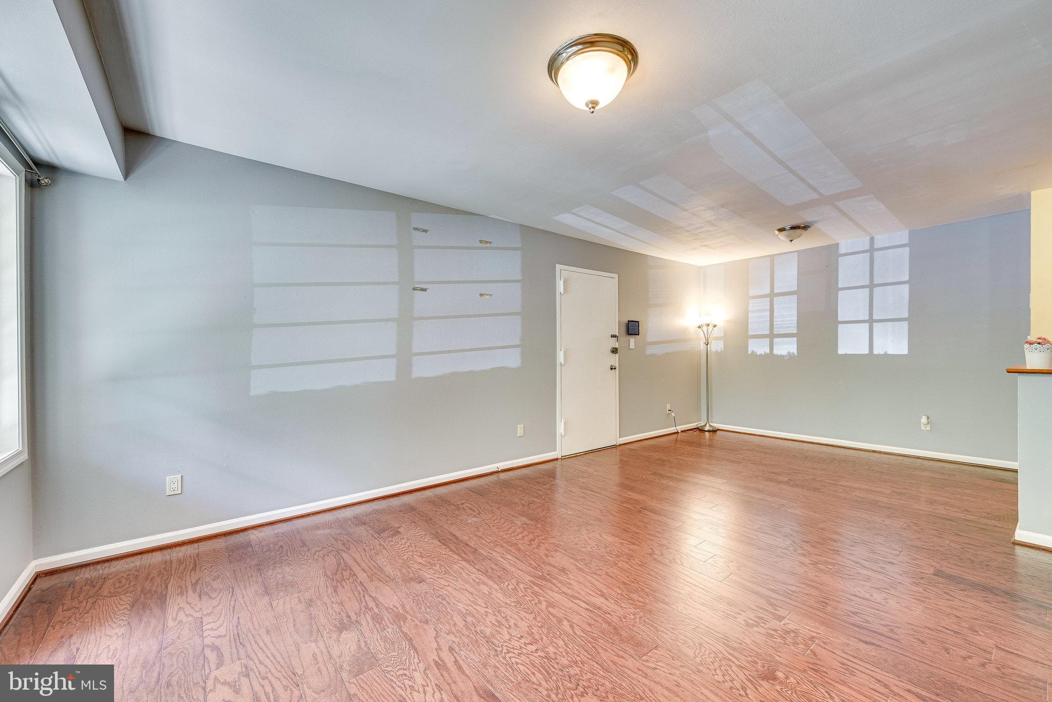 5909 B Prince James Drive, Unit B Springfield, VA 22152 - Photo 6 of 18 an empty room with wooden floor and windows