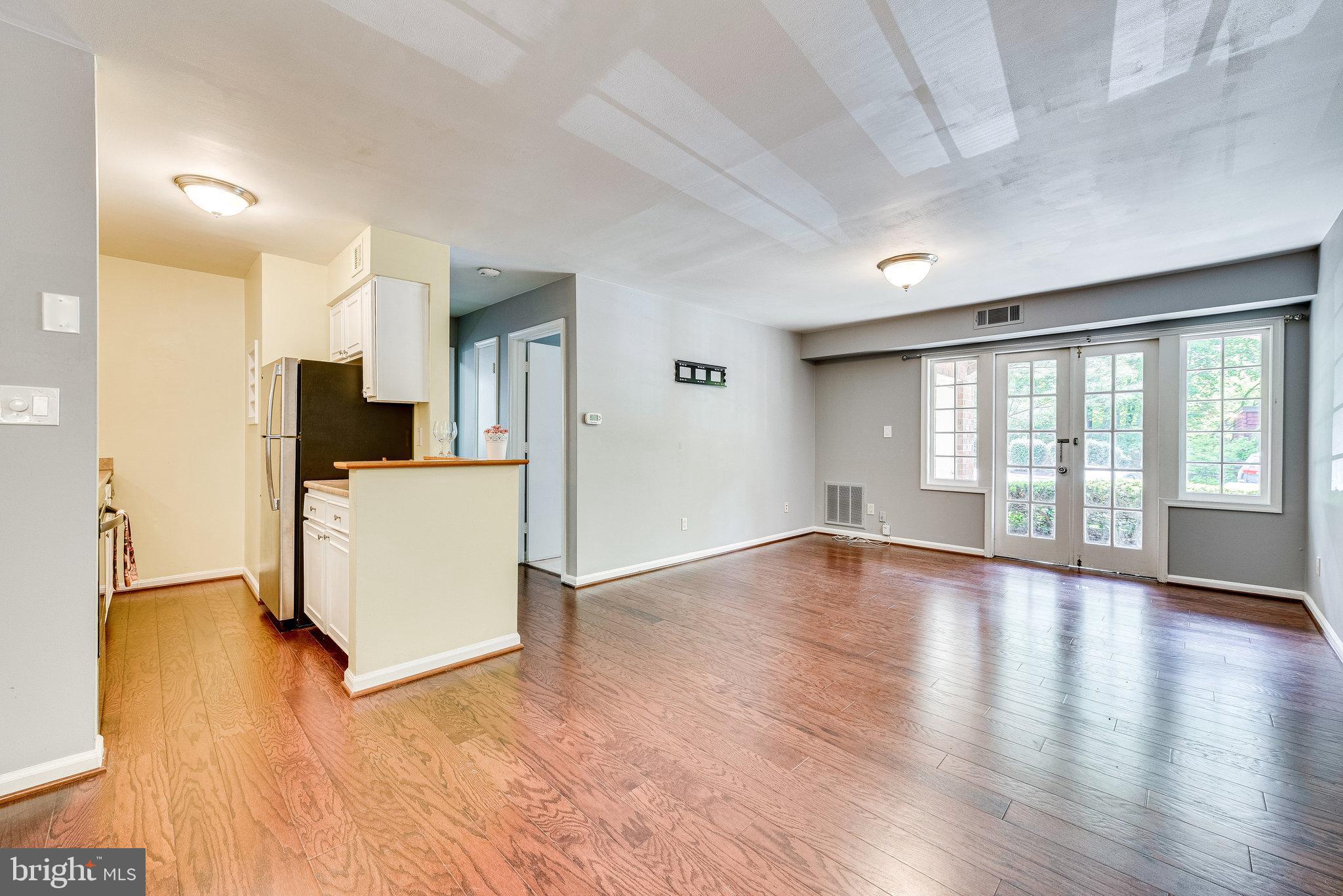 5909 B Prince James Drive, Unit B Springfield, VA 22152 - Photo 18 of 18 a view of empty room with wooden floor and windows