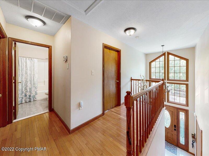 1080 Hampstead Road Bushkill, PA 18324 - Photo 21 of 62 a view of a hallway with wooden floor and windows