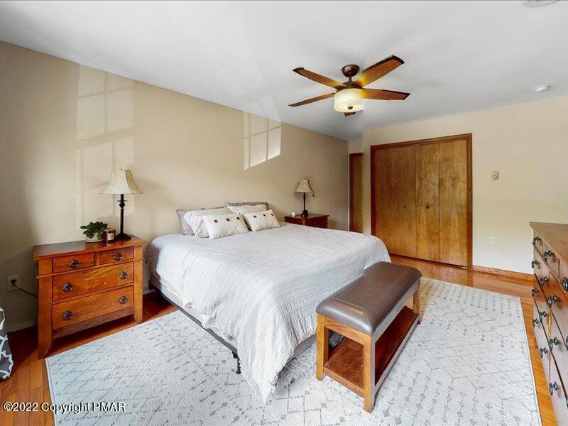 1080 Hampstead Road Bushkill, PA 18324 - Photo 25 of 62 a bedroom with a bed and a chandelier