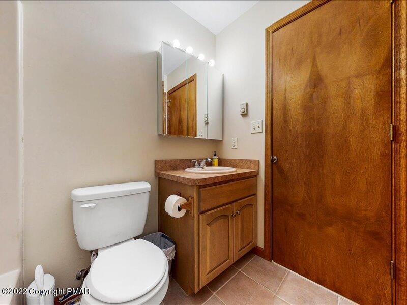 1080 Hampstead Road Bushkill, PA 18324 - Photo 28 of 62 a bathroom with a sink a toilet and a mirror