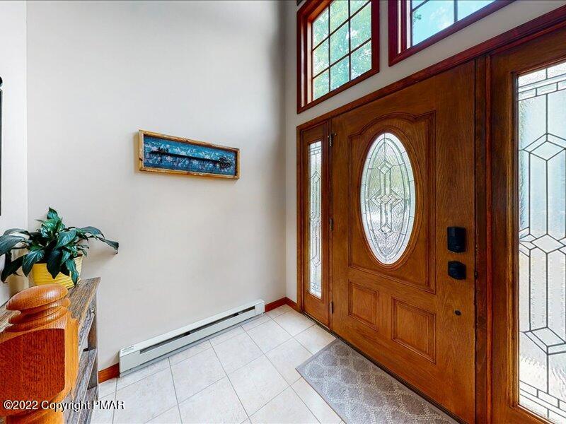 1080 Hampstead Road Bushkill, PA 18324 - Photo 5 of 62 a view of a hallway with entryway wooden floor and front door