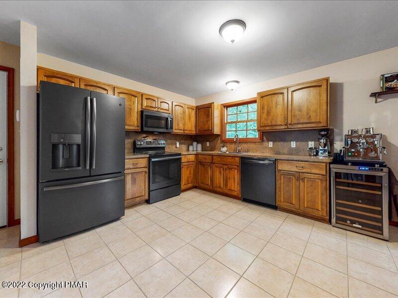1080 Hampstead Road Bushkill, PA 18324 - Photo 7 of 62 a kitchen with stainless steel appliances granite countertop a stove top oven a sink and a refrigerator