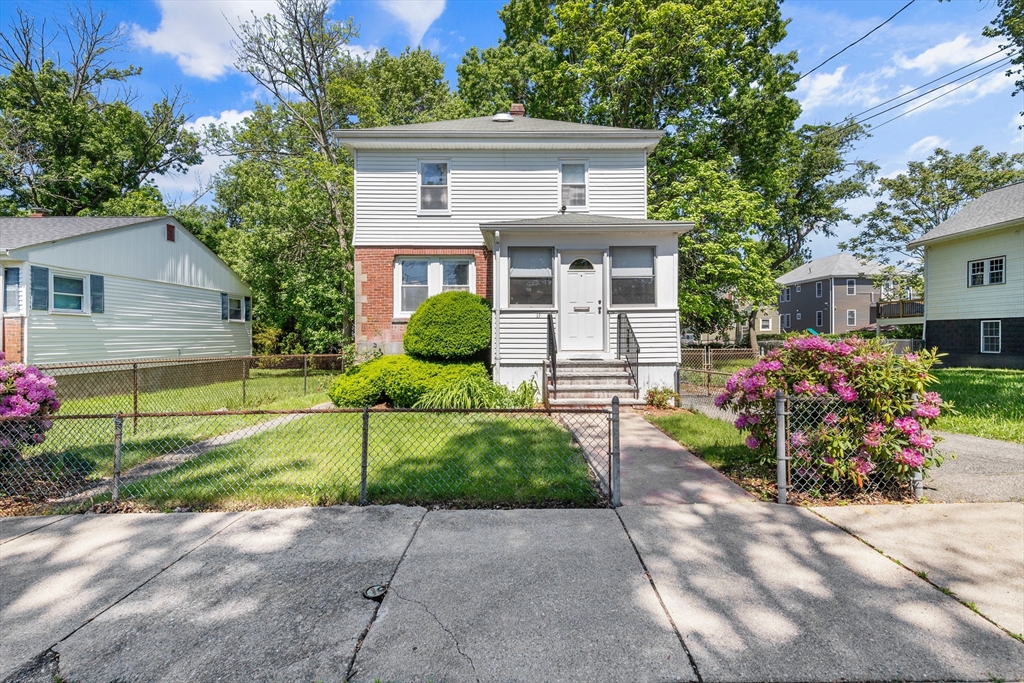 27 Colorado Street Boston, MA 02126 - Photo 1 of 32 a front view of a house with a yard and a garage