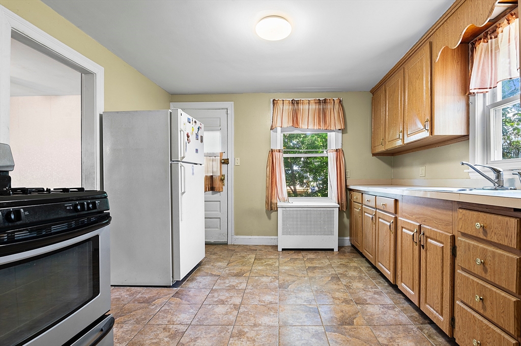 27 Colorado Street Boston, MA 02126 - Photo 20 of 32 a kitchen with a refrigerator and a sink