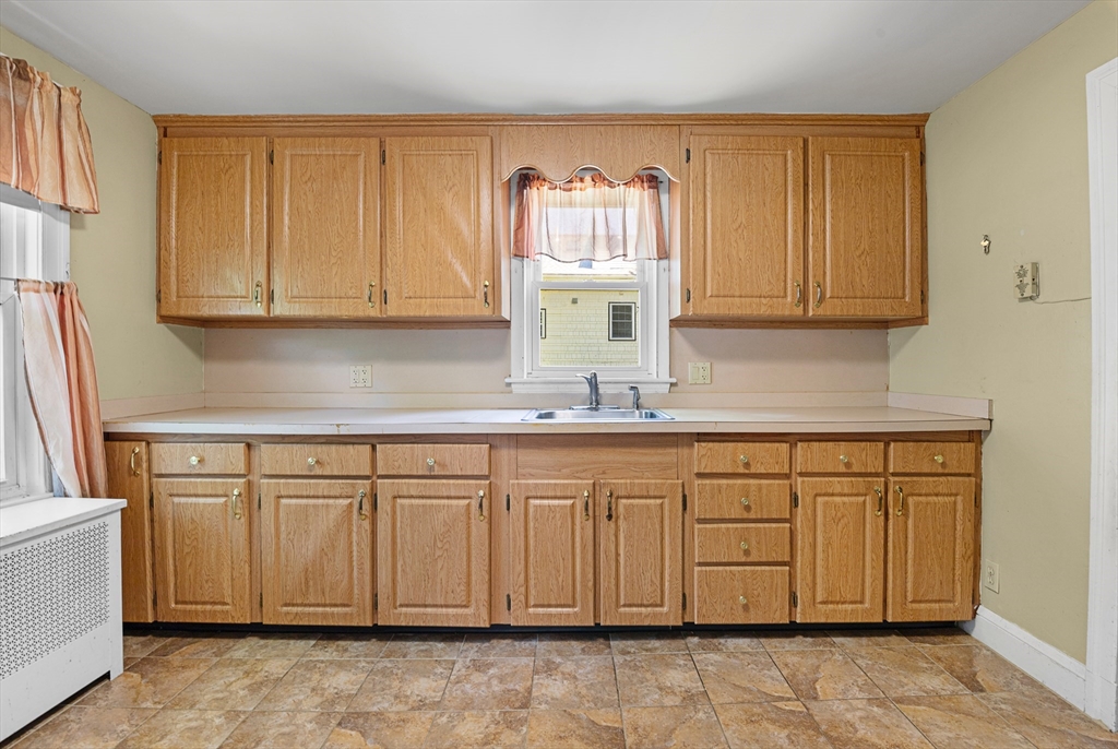 27 Colorado Street Boston, MA 02126 - Photo 21 of 32 a kitchen with granite countertop cabinets sink and a granite counter tops