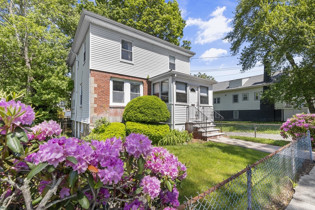 27 Colorado Street Boston, MA 02126 - Photo 4 of 32 a front view of house and yard with beautiful flowers and green space