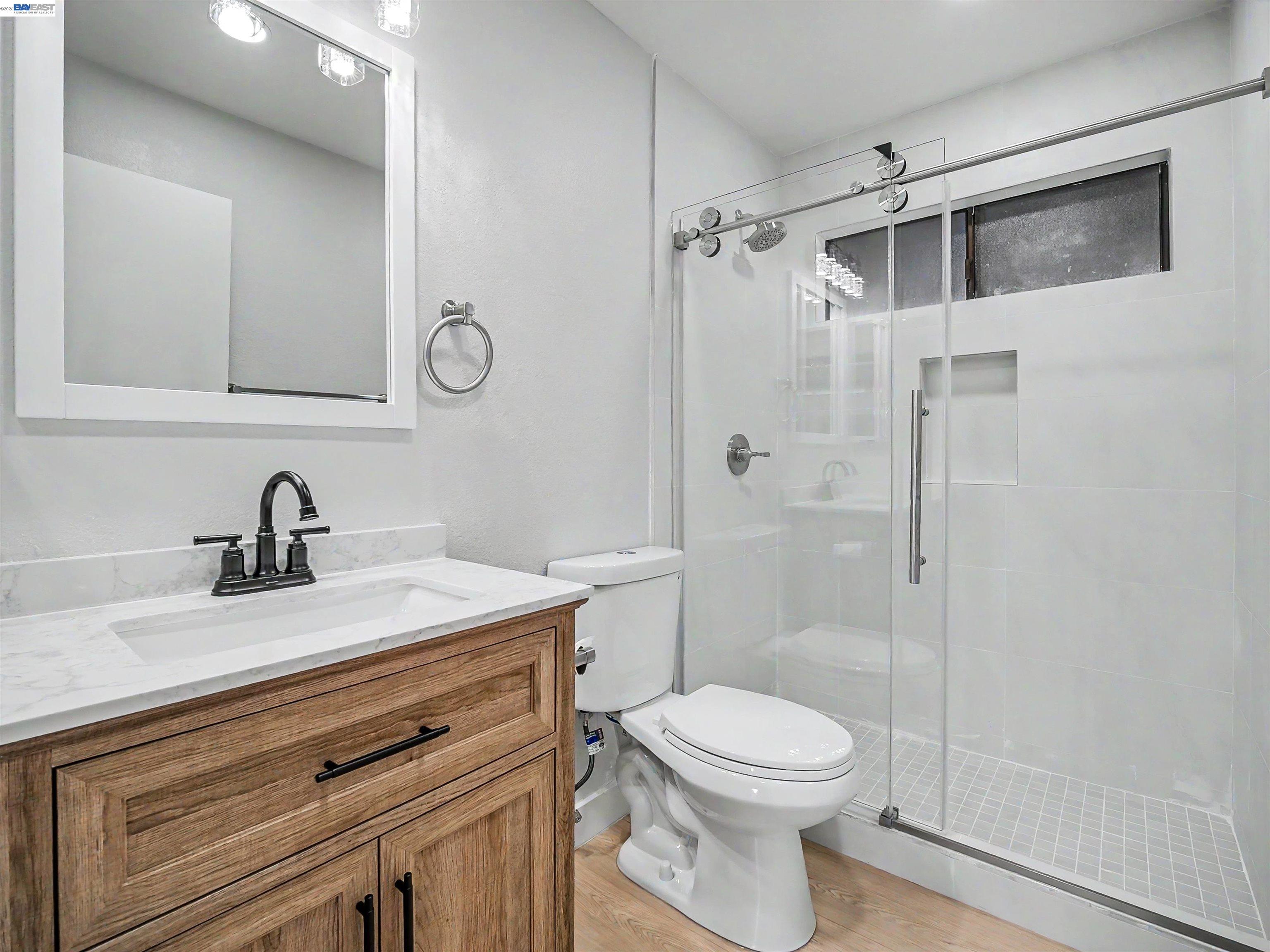 39450 Albany Common, Unit X Fremont, CA 94538 - Photo 18 of 46 a bathroom with a sink a toilet and shower