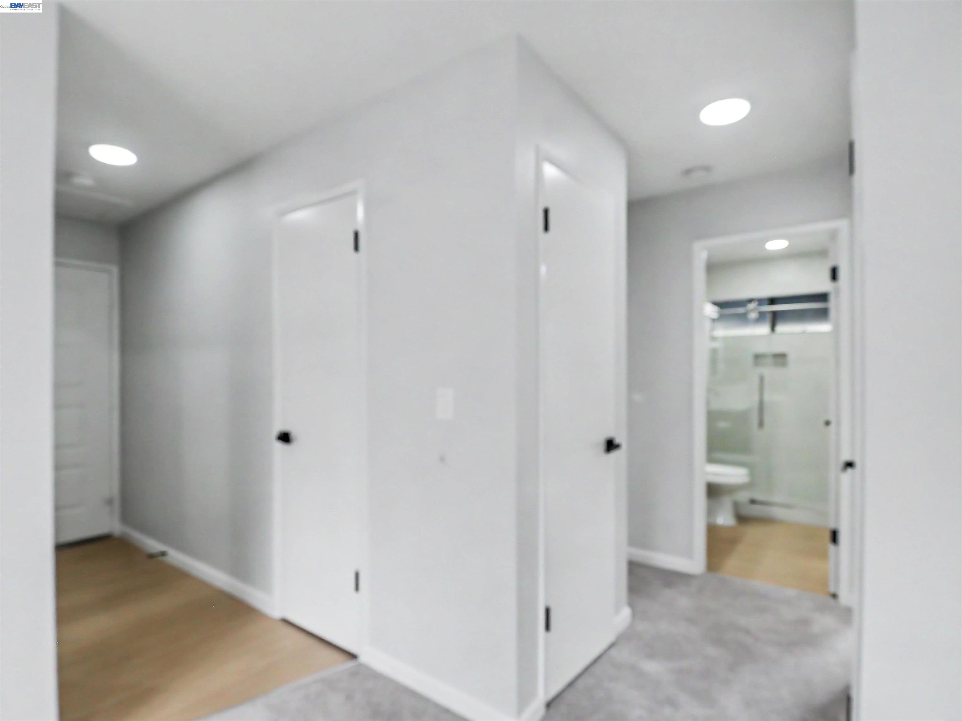 39450 Albany Common, Unit X Fremont, CA 94538 - Photo 27 of 46 a view of a hallway with wooden shelves