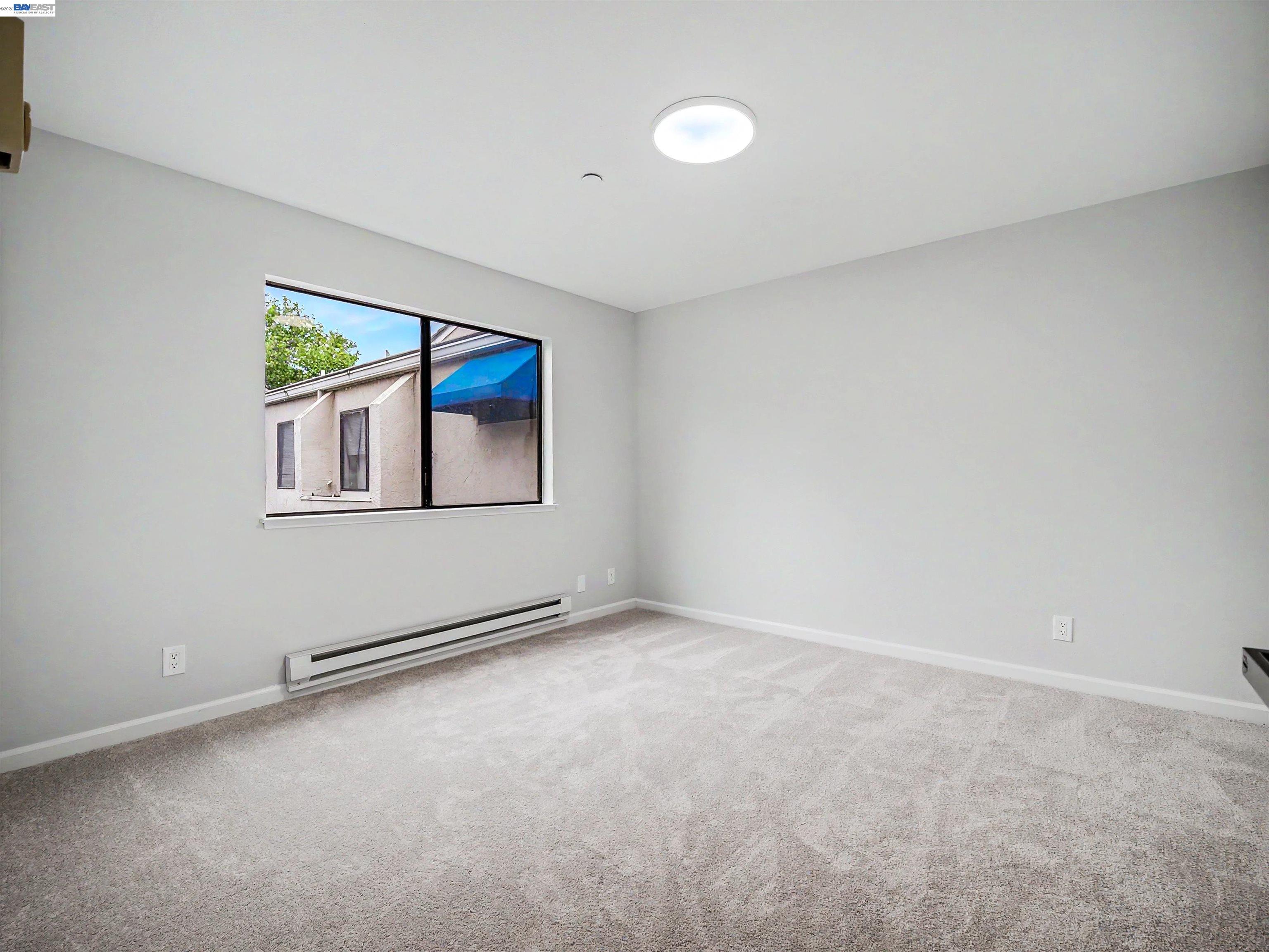39450 Albany Common, Unit X Fremont, CA 94538 - Photo 29 of 46 an empty room with windows and fan