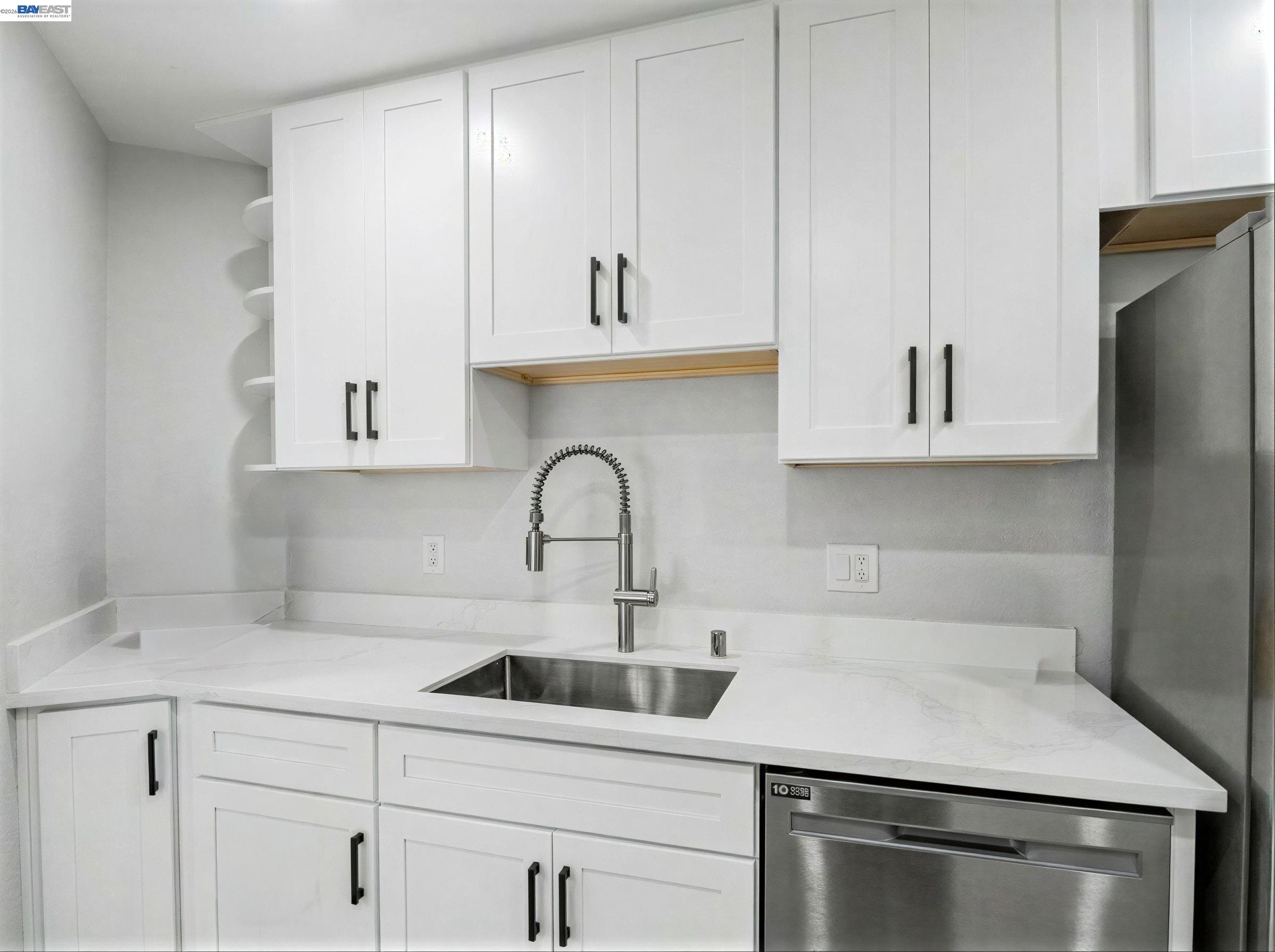 39450 Albany Common, Unit X Fremont, CA 94538 - Photo 10 of 46 a kitchen with white cabinets stainless steel appliances and sink
