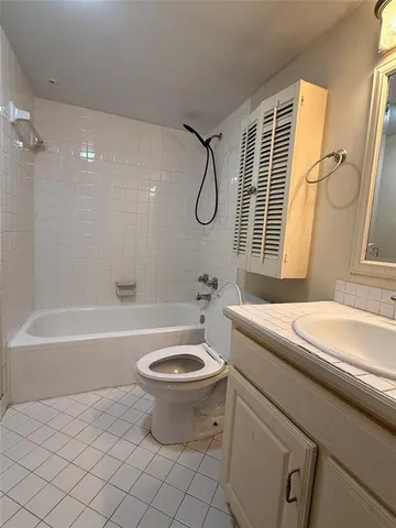 a bathroom with a granite countertop sink toilet a mirror and shower
