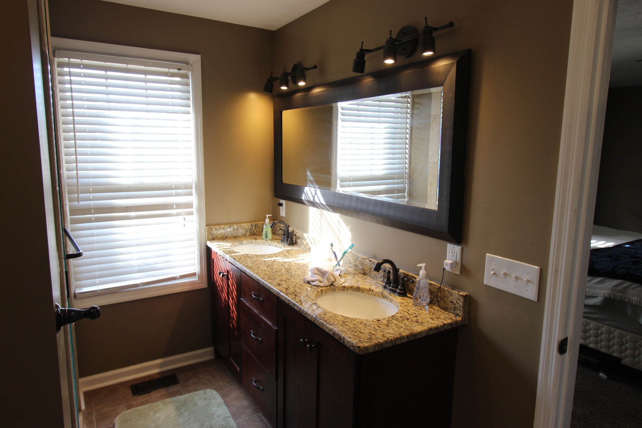 1360 Cedar Grove Road Lebanon, TN 37087 - Photo 16 of 29 a bathroom with a granite countertop sink and a window