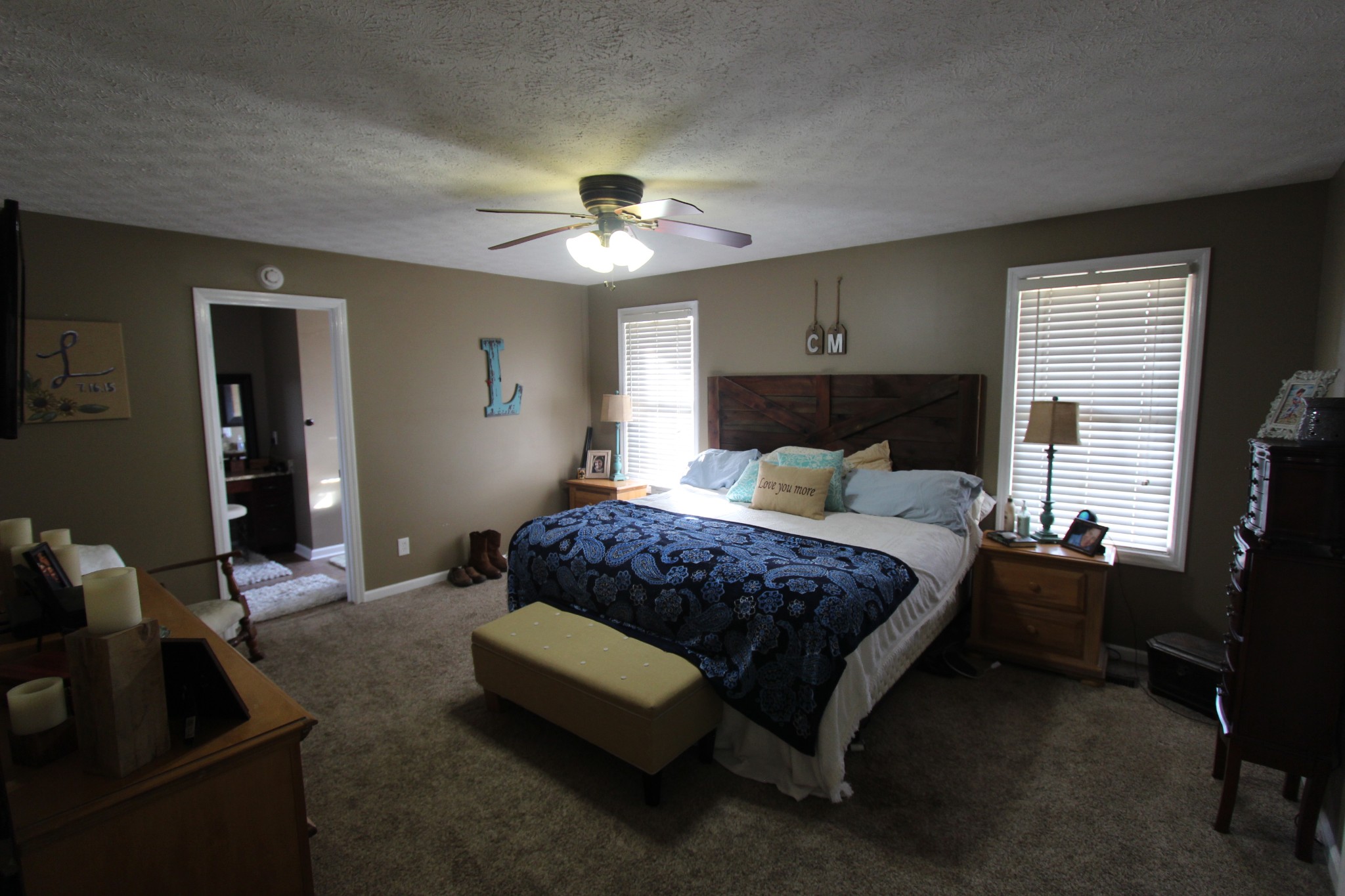 1360 Cedar Grove Road Lebanon, TN 37087 - Photo 17 of 29 a bedroom with a bed and a chandelier