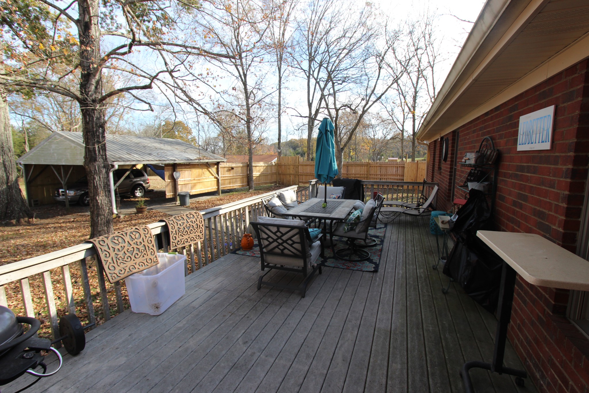 1360 Cedar Grove Road Lebanon, TN 37087 - Photo 23 of 29 a view of a patio with dining table and chairs with wooden floor and fence