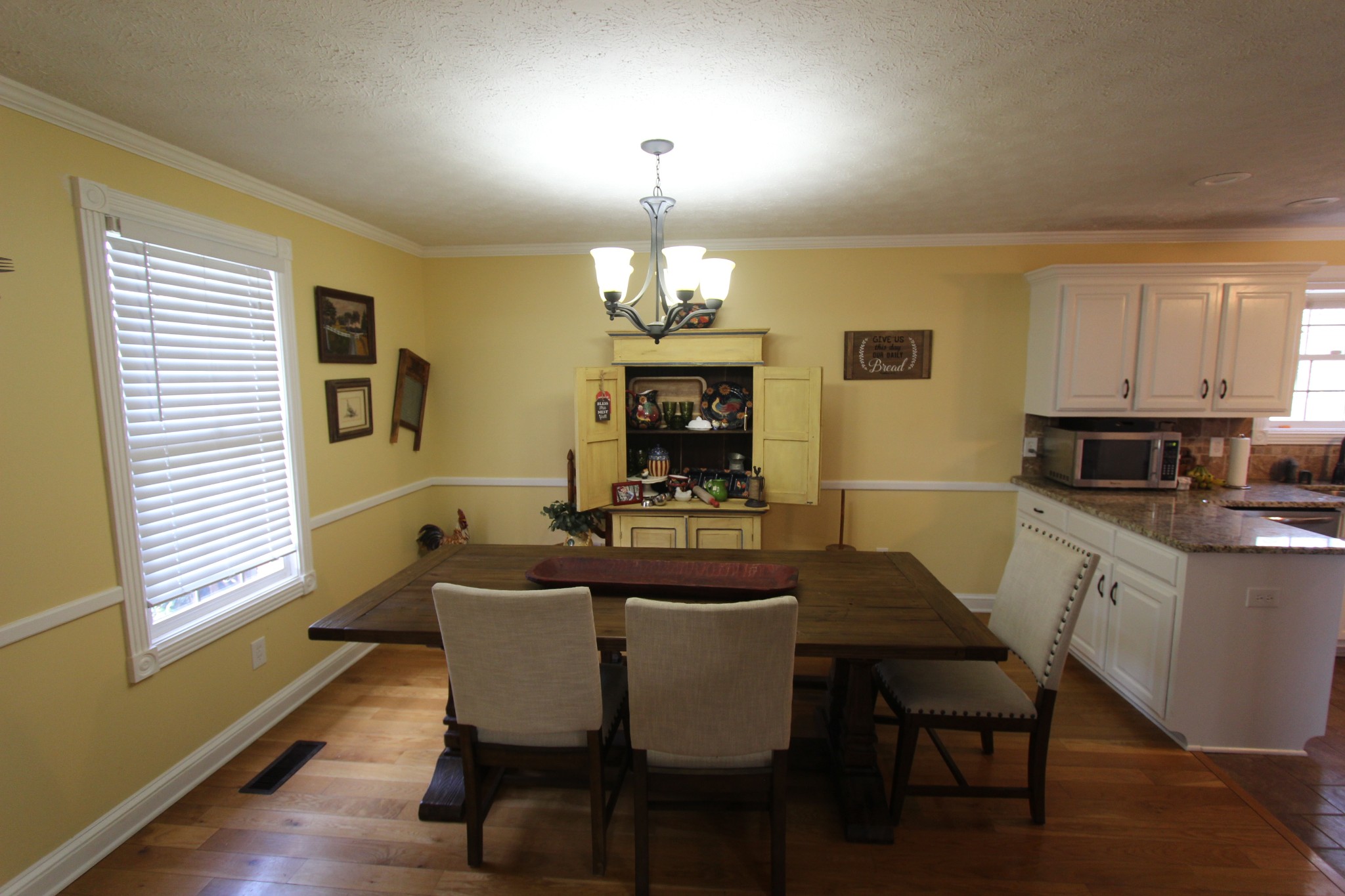 1360 Cedar Grove Road Lebanon, TN 37087 - Photo 8 of 29 a dining room with wooden floor a chandelier a wooden table and chairs