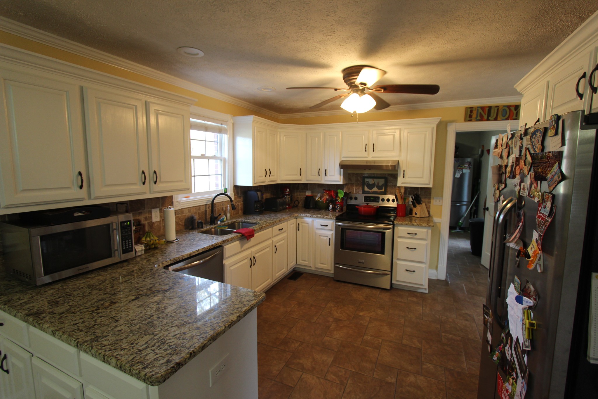1360 Cedar Grove Road Lebanon, TN 37087 - Photo 9 of 29 a kitchen with a stove a sink and a microwave