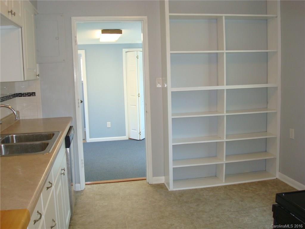 744 Manhasset Road Charlotte, NC 28209 - Photo 8 of 20 a kitchen with a cabinets and a stove top oven