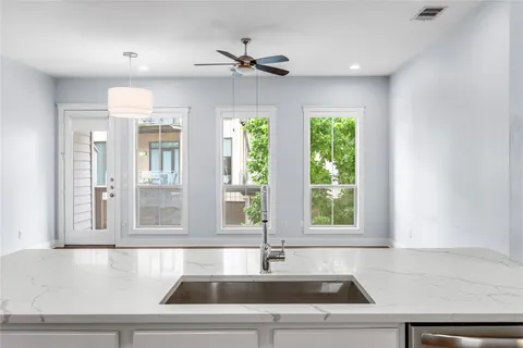 a kitchen with a sink and windows
