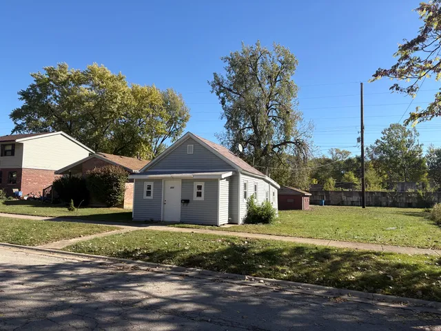 a front view of a house with a garden and yard