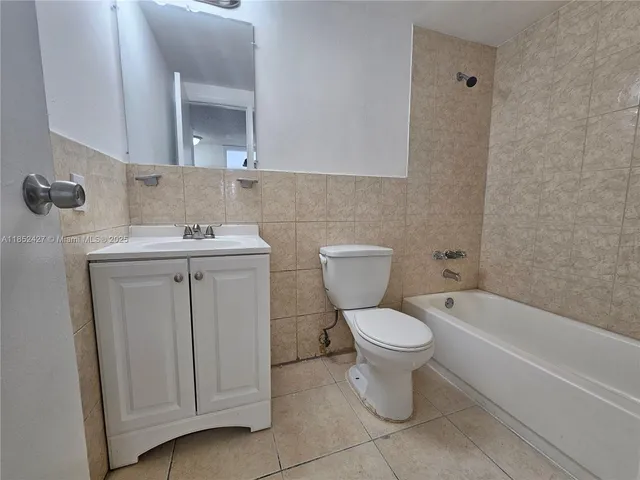 a bathroom with a sink toilet and a mirror