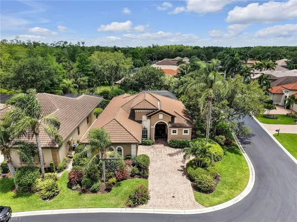 a aerial view of a house with a yard and lake