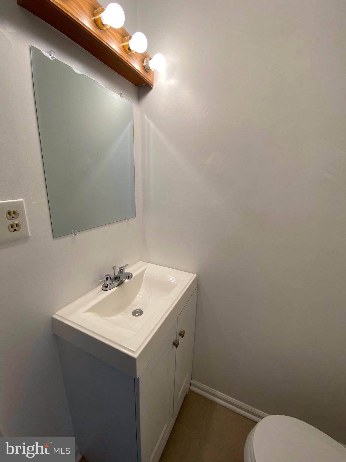 8807 Trimble Way Baltimore, MD 21237 - Photo 9 of 32 First Floor half bathroom view w/ new sink vanity