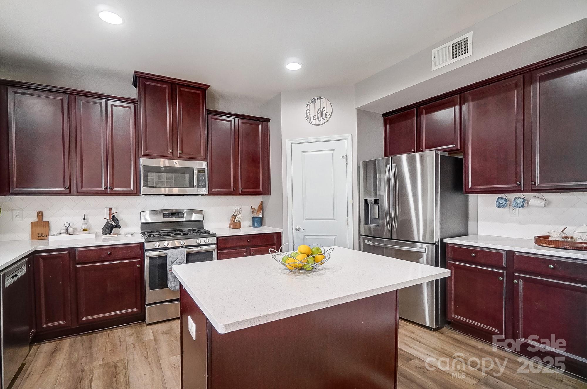 2065 Taney Way Indian Land, SC 29707 - Photo 15 of 43 a kitchen with a sink a stove a refrigerator and wooden cabinets